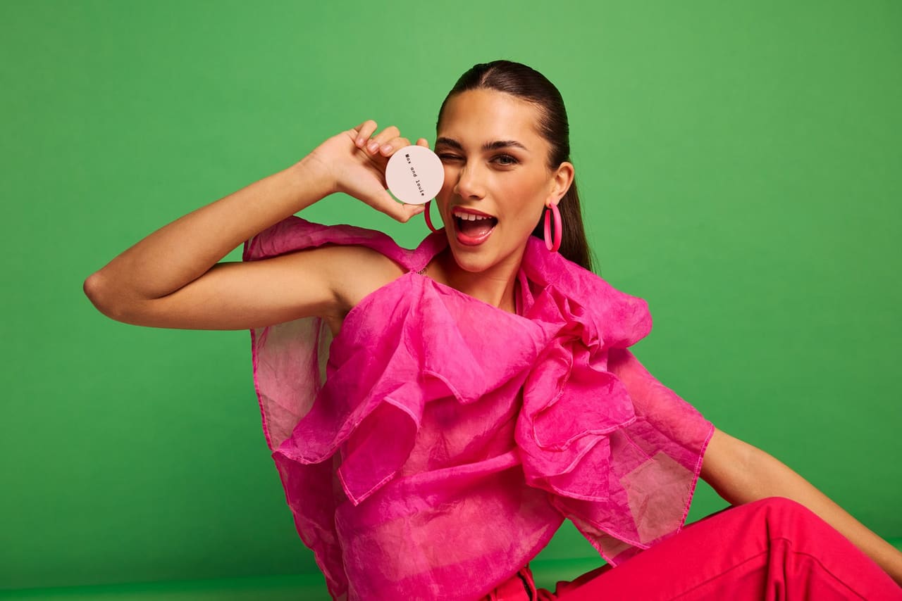A guest in pink against a green wall
