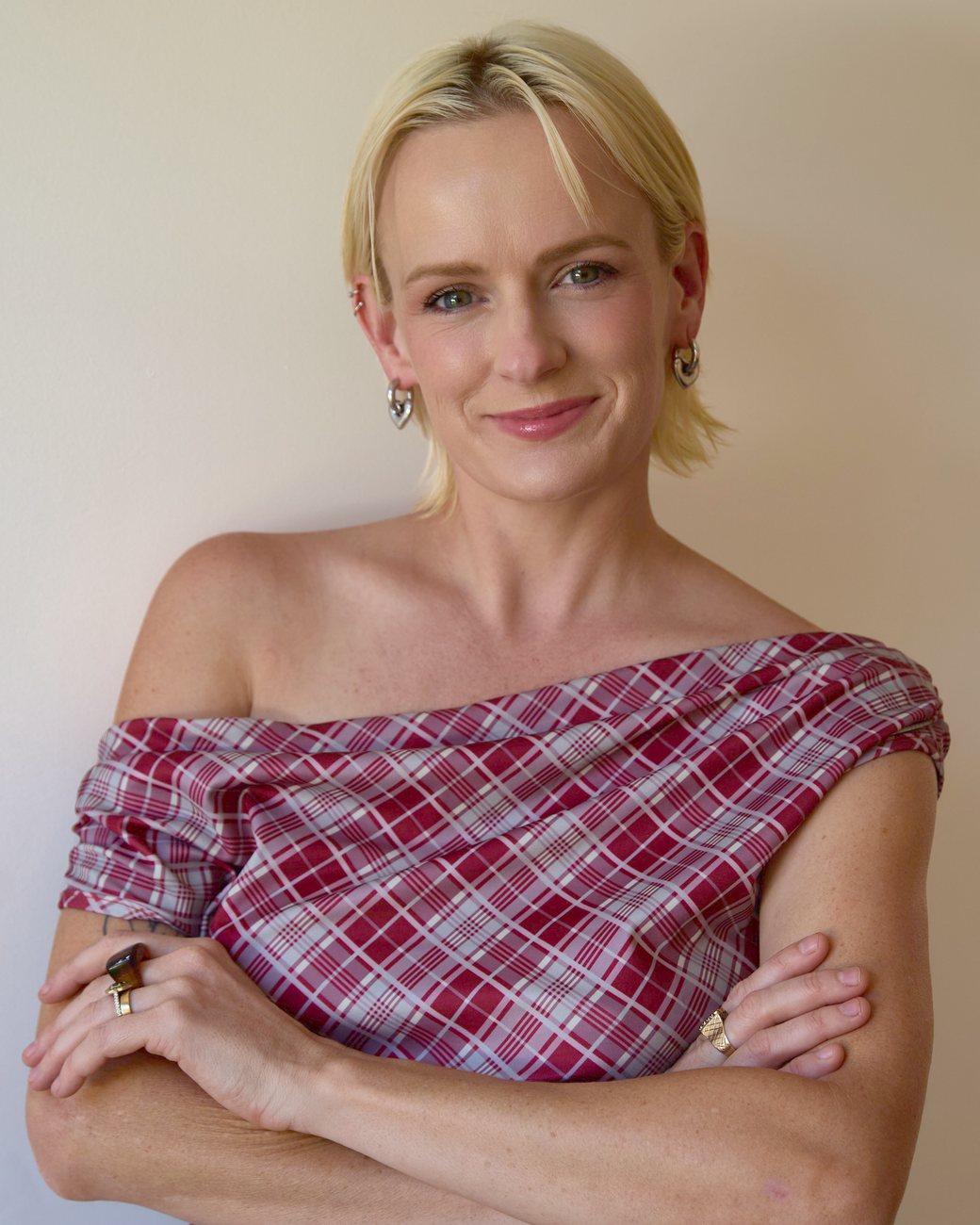 Olive, arms folded, smiling at the camera